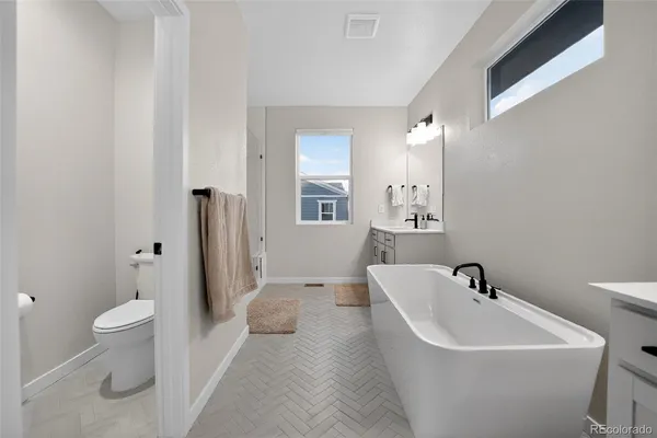 a white bath tub sitting next to a white toilet