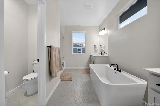 a white bath tub sitting next to a white toilet