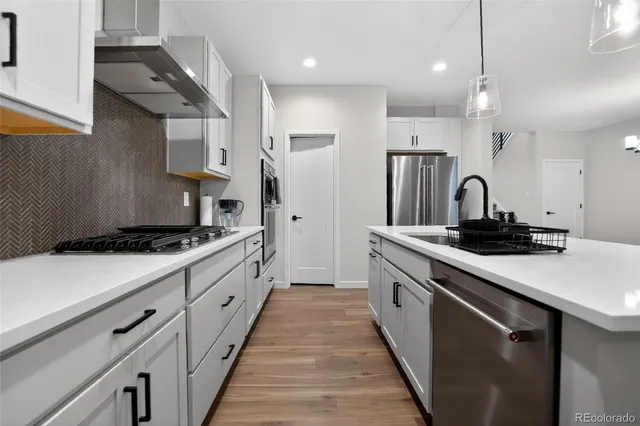 a large kitchen with stainless steel appliances