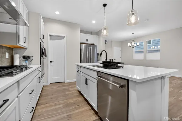 a kitchen with a sink stove and refrigerator