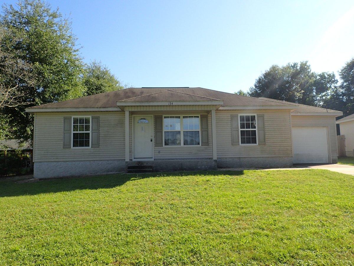 134 Hampton Drive Crestview, FL 32539 - Photo 1 of 17 a house view with a garden space