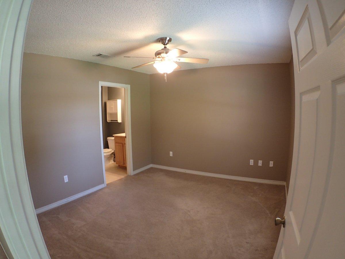 134 Hampton Drive Crestview, FL 32539 - Photo 3 of 17 wooden floor in an empty room with a window