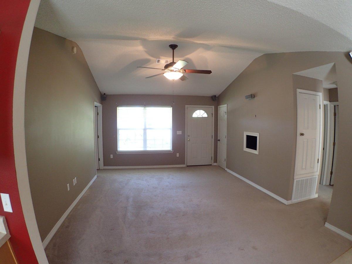 134 Hampton Drive Crestview, FL 32539 - Photo 7 of 17 an empty room with chandelier fan and windows