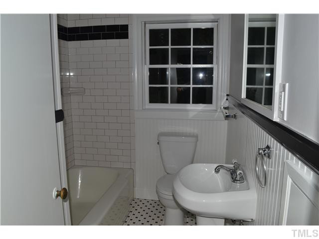 2524 Pickett Road Durham, NC 27705 - Photo 9 of 20 Second bathroom has the same small black and white tiles in the tiled flooring. The tub/shower has the same black and white theme. Bathroom