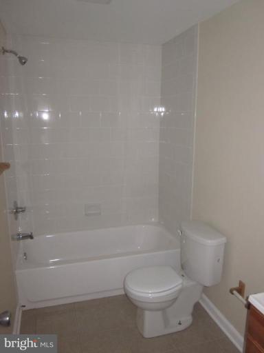 1120 North Point Road Dundalk, MD 21222 - Photo 2 of 14 a white toilet and tub sitting next to a bathroom sink