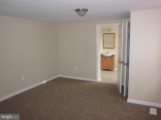 1120 North Point Road Dundalk, MD 21222 - Photo 4 of 14 a view of a room with a bench and closet