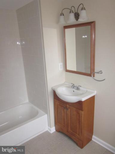 1120 North Point Road Dundalk, MD 21222 - Photo 5 of 14 a bathroom with a sink and a mirror