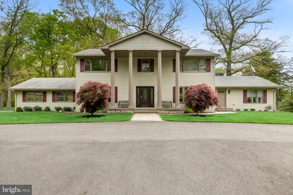 a front view of house with yard and green space
