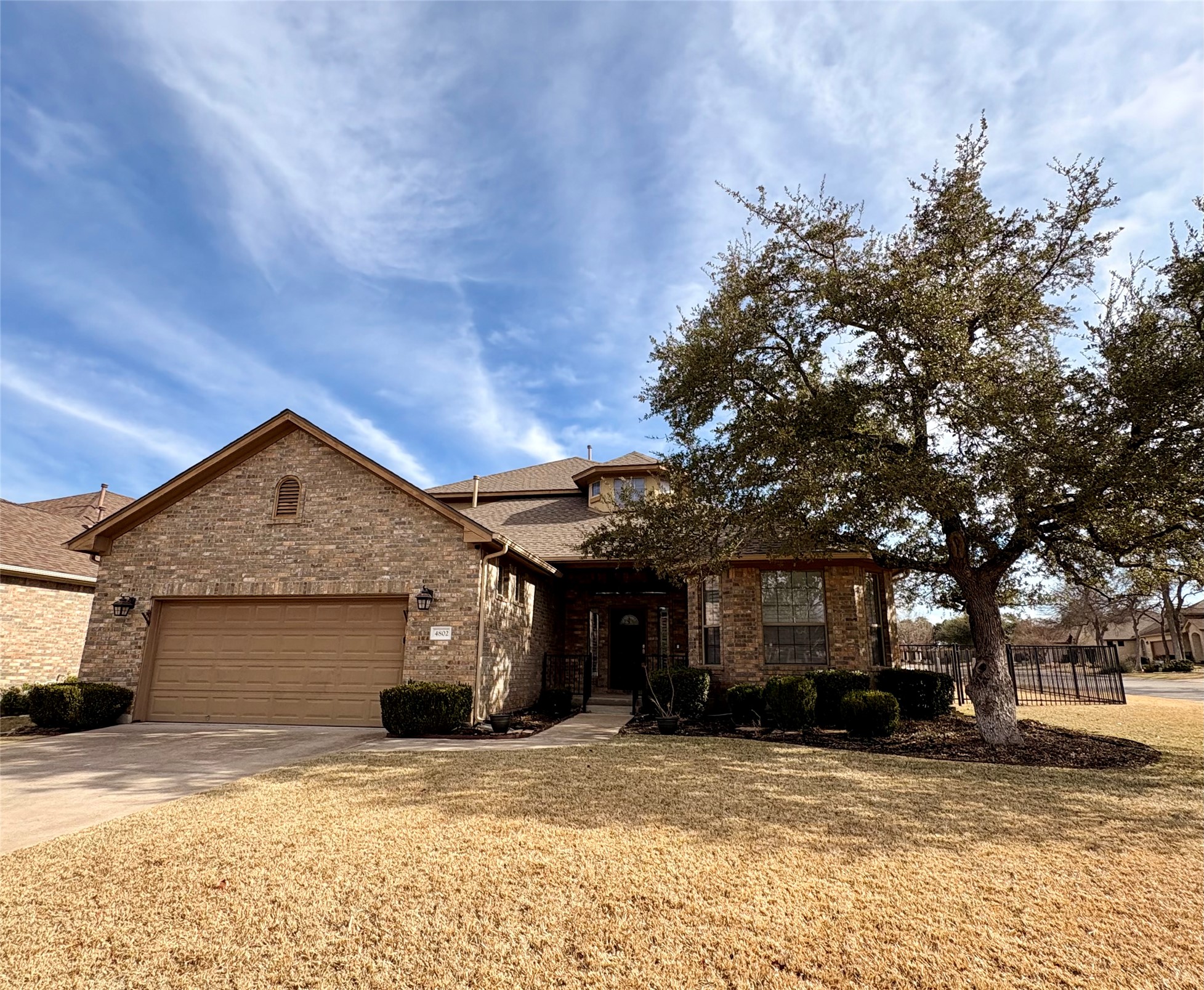 View of front of house featuring concrete driveway and a garage