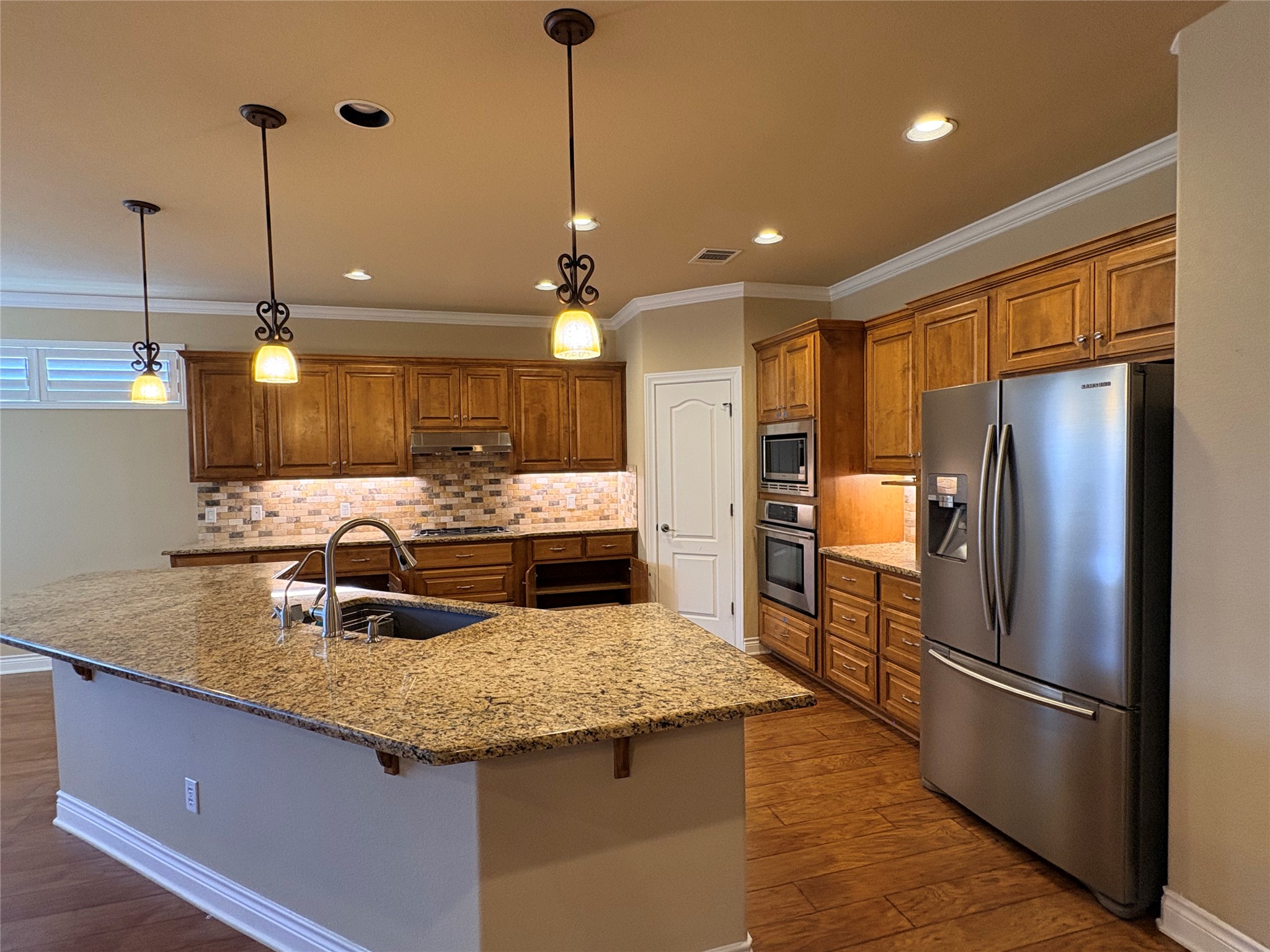 4802 Hidden Springs Trail Georgetown, TX 78633 - Photo 7 of 33 Fabulous kitchen offers generous breakfast bar - and the wood floors continue!
