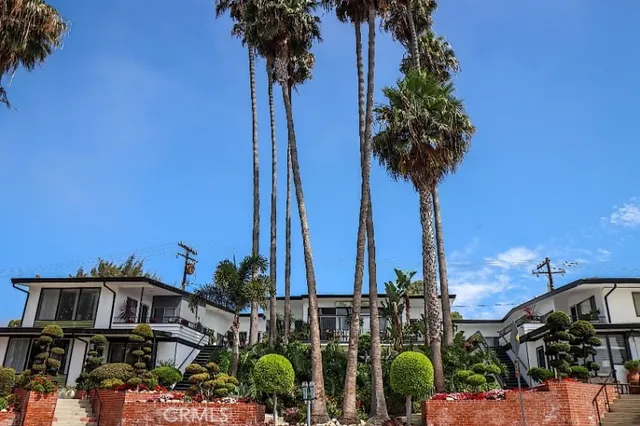 a view of a tall building next to a yard