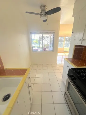 a view of a kitchen with an empty space and a window