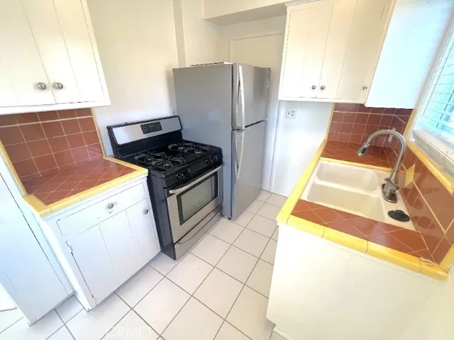 a kitchen with a stove top oven and cabinets