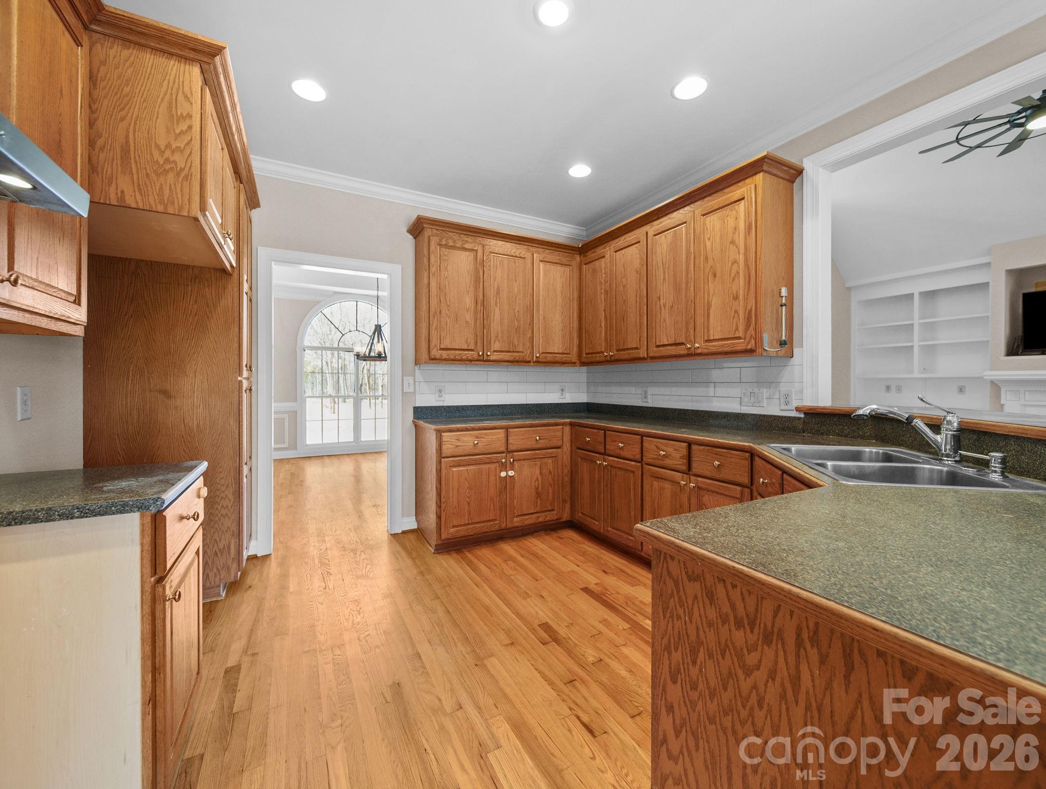 715 Witmore Road Wingate, NC 28174 - Photo 13 of 48 a kitchen with granite countertop wooden floors a stove and a microwave