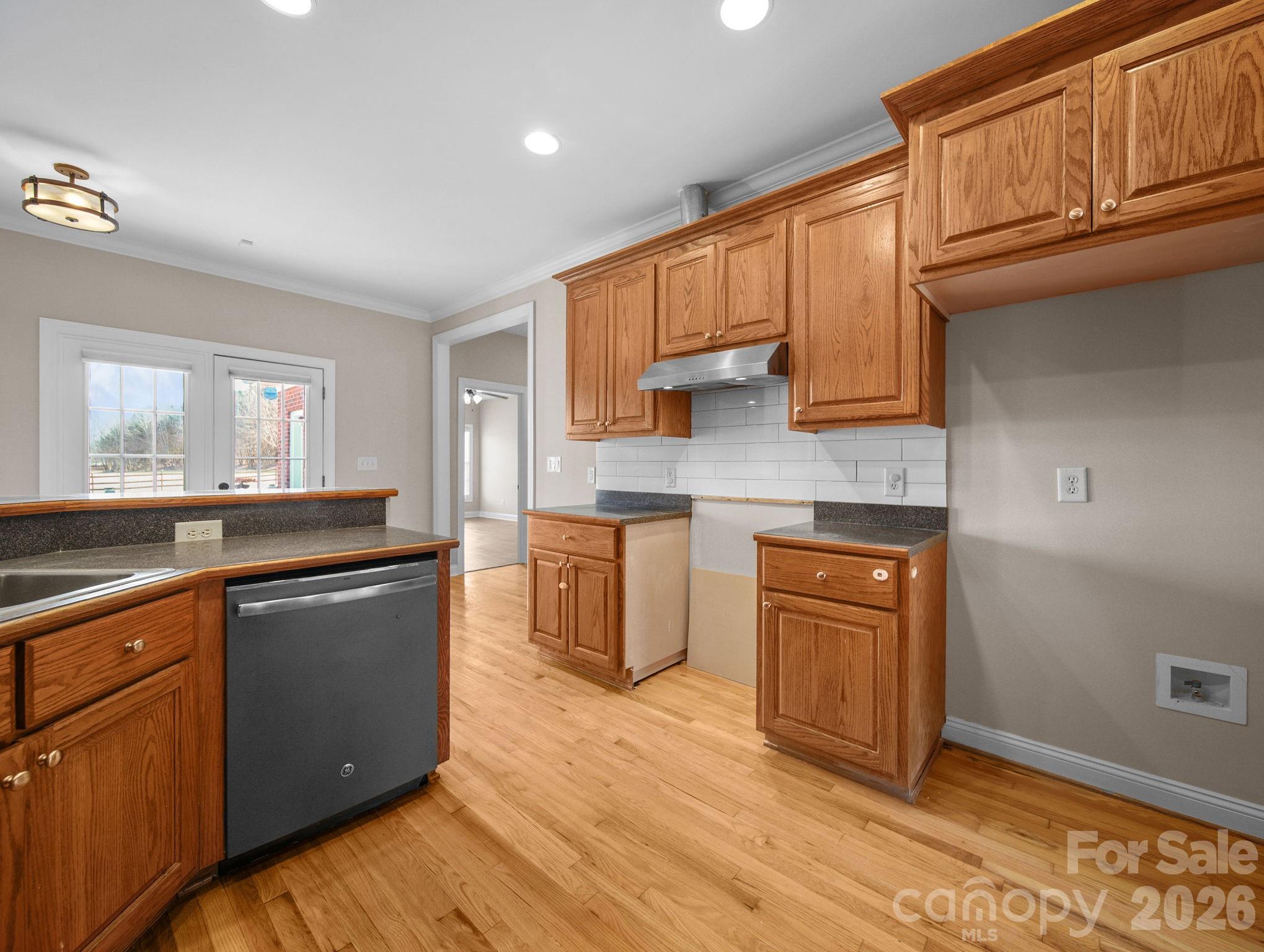 715 Witmore Road Wingate, NC 28174 - Photo 14 of 48 a kitchen with stainless steel appliances granite countertop a sink stove and wooden cabinets