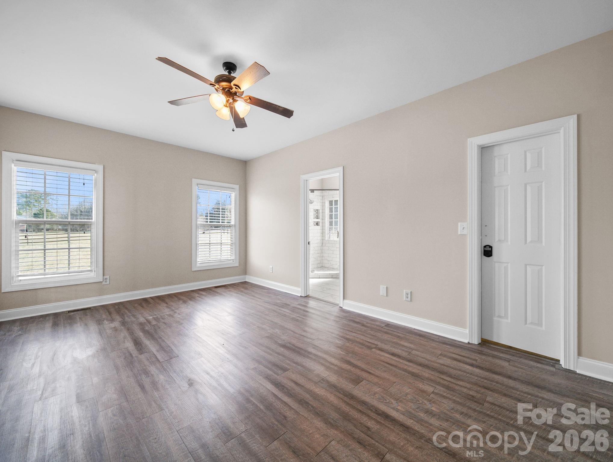 715 Witmore Road Wingate, NC 28174 - Photo 19 of 48 a view of empty room with wooden floor and fan