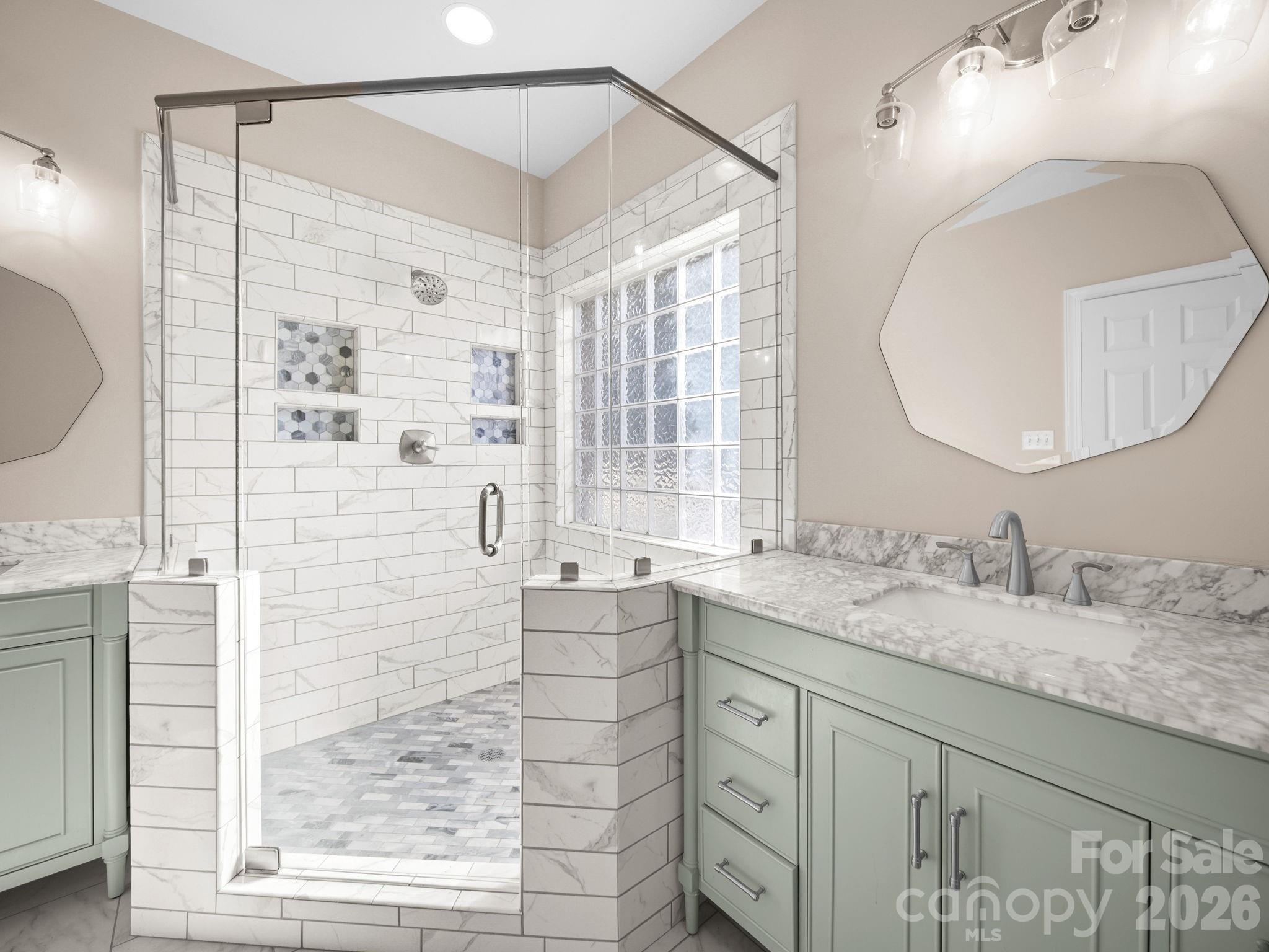 715 Witmore Road Wingate, NC 28174 - Photo 21 of 48 a bathroom with a granite countertop sink a mirror a vanity and shower