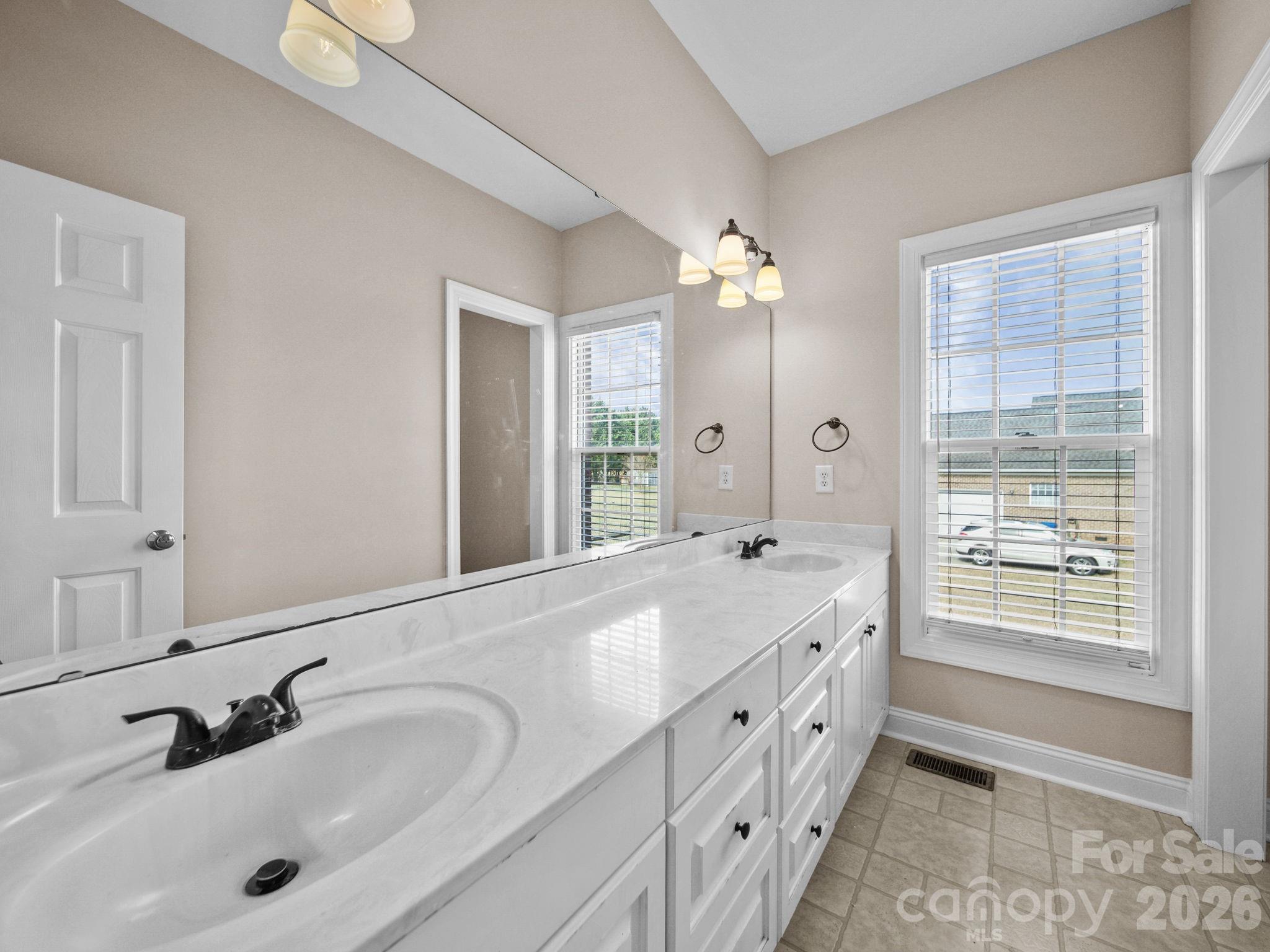 715 Witmore Road Wingate, NC 28174 - Photo 25 of 48 a spacious bathroom with double sink and a large mirror