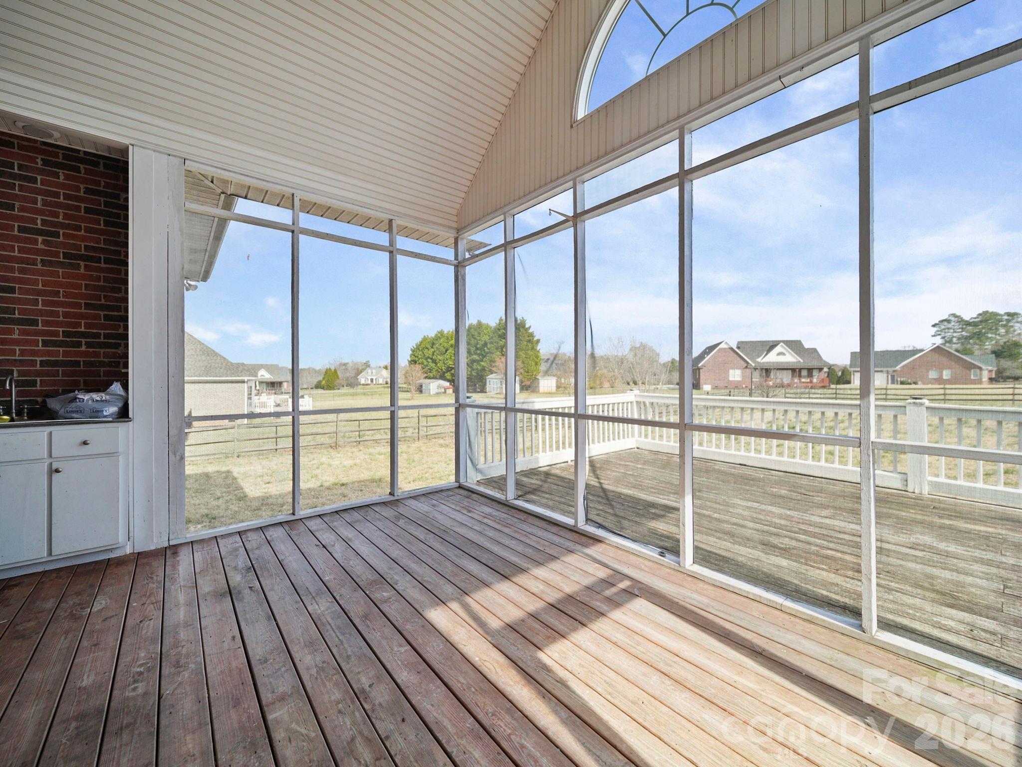 715 Witmore Road Wingate, NC 28174 - Photo 33 of 48 a view of balcony with floor to ceiling windows with wooden floor