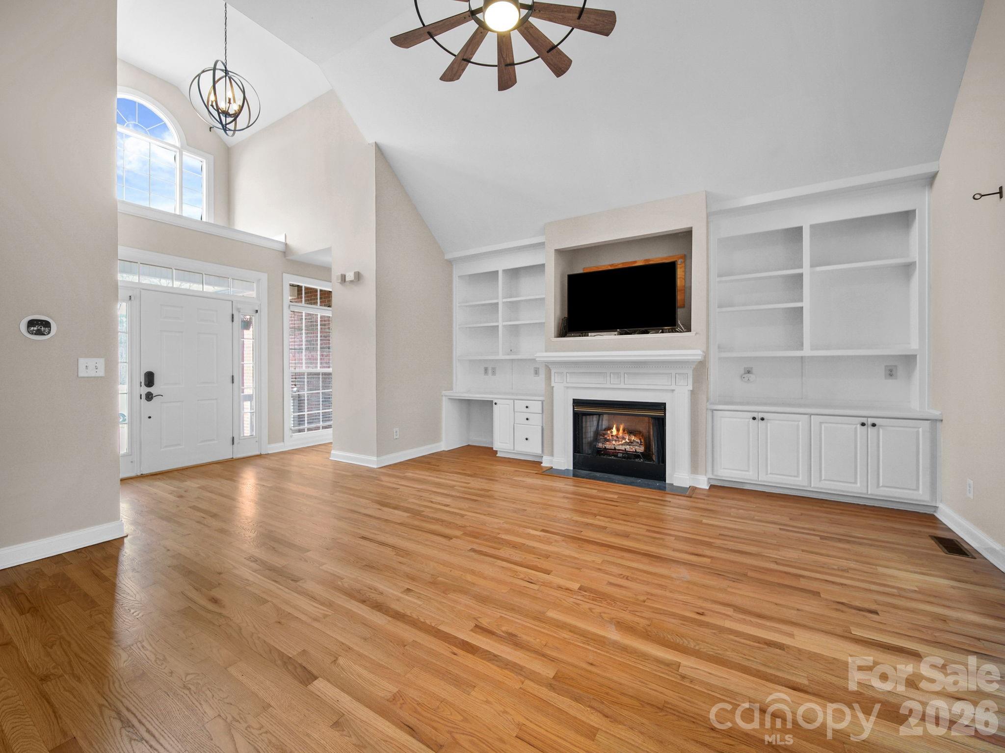 715 Witmore Road Wingate, NC 28174 - Photo 6 of 48 a view of an empty room with wooden floor fireplace and a window