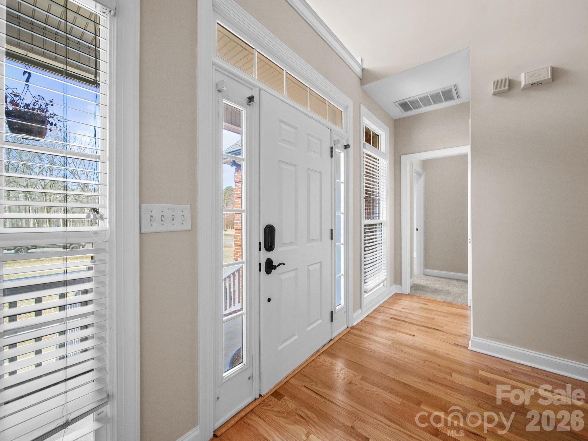 715 Witmore Road Wingate, NC 28174 - Photo 7 of 48 a view of a hallway with wooden floor and closet area