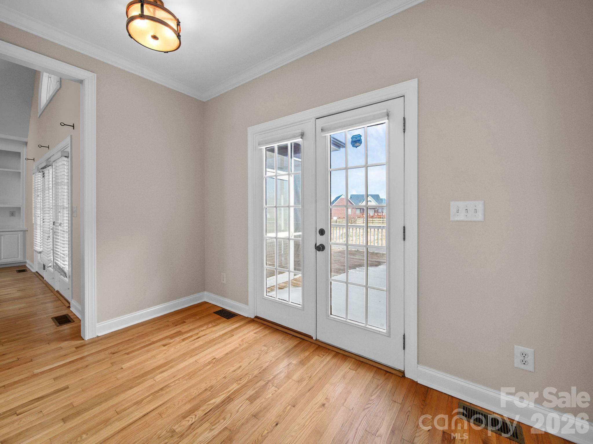 715 Witmore Road Wingate, NC 28174 - Photo 10 of 48 a view of an empty room with wooden floor and a window