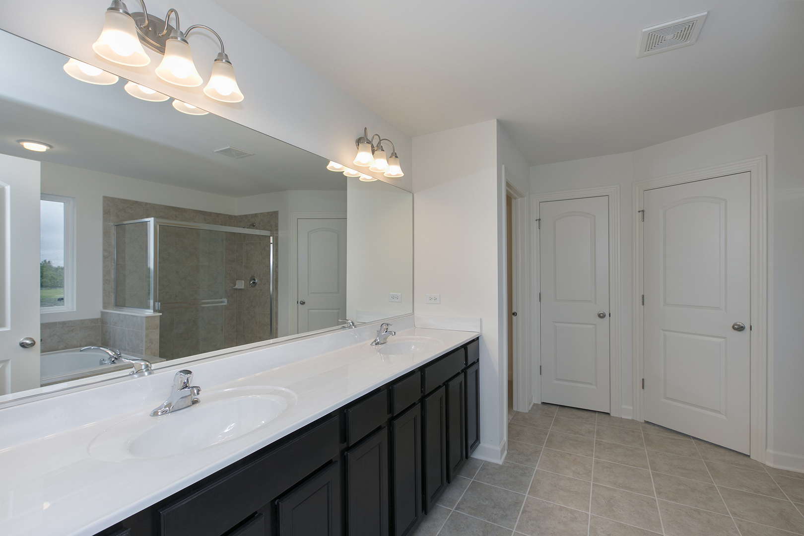 4398 Charles Dickens Road Elgin, IL 60124 - Photo 20 of 29 a bathroom with a double vanity sink and a mirror