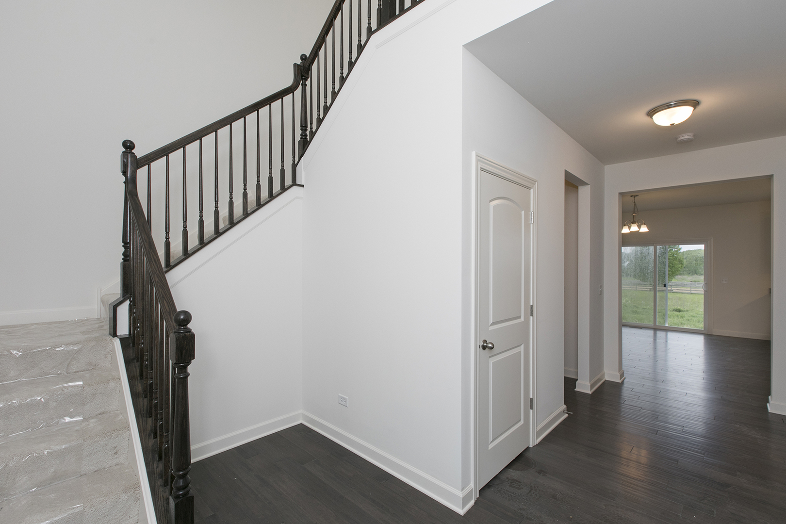 4398 Charles Dickens Road Elgin, IL 60124 - Photo 3 of 29 a view of a hallway with wooden floor and staircase