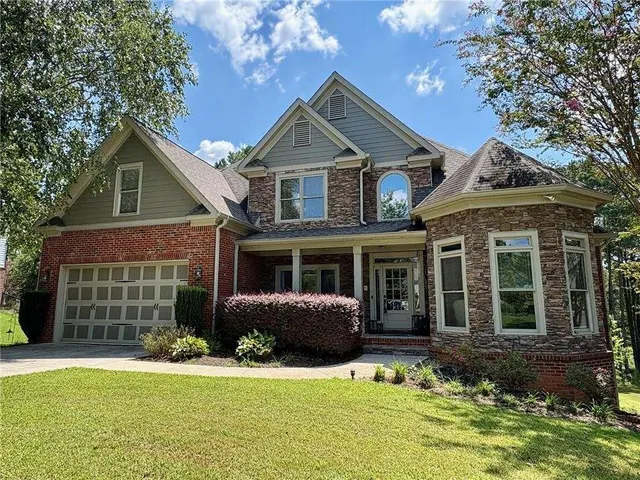 a front view of a house with a yard and garage