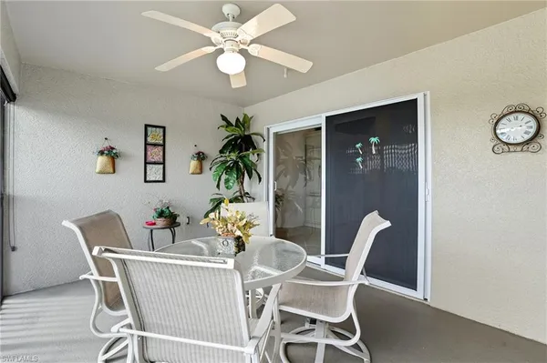 a view of a dining room with furniture and a chandelier fan