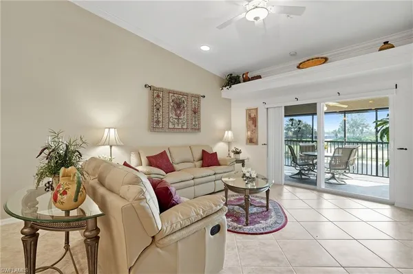 a living room with furniture and a floor to ceiling window