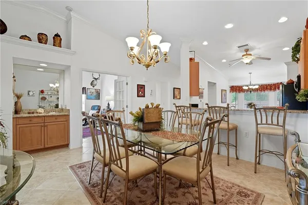 a view of a dining room with furniture and a chandelier