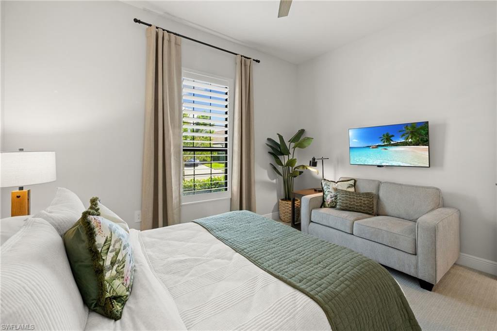 3967 Pegasus Way Naples, FL 34120 - Photo 17 of 50 a bedroom with a large bed couch and a potted plant