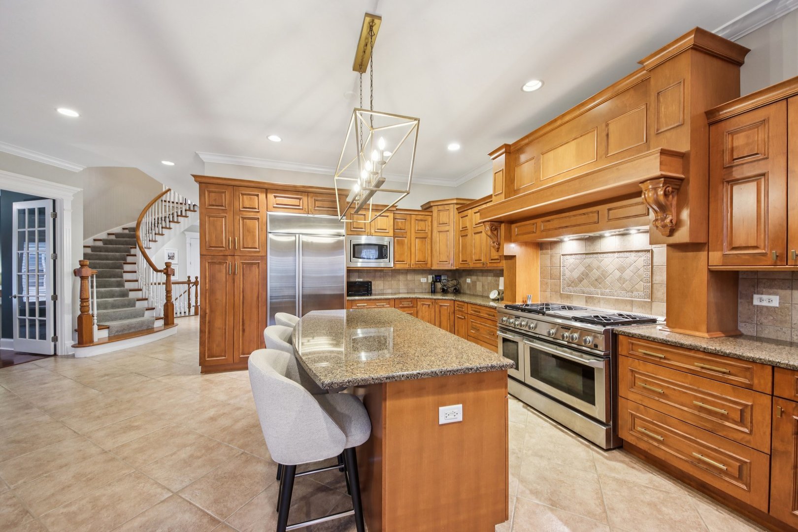 1135 North Main Street Naperville, IL 60563 - Photo 13 of 52 a kitchen with stainless steel appliances granite countertop a sink a stove and a refrigerator