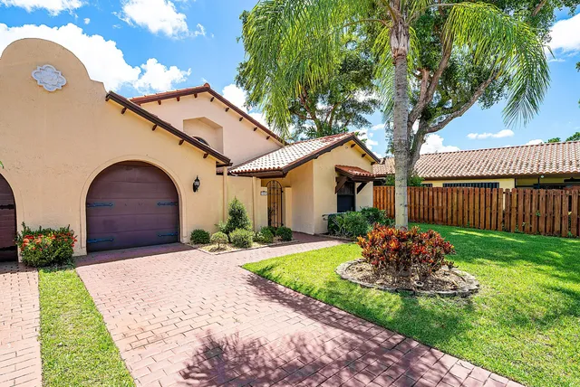 a dining room with furniture and a floor to ceiling window