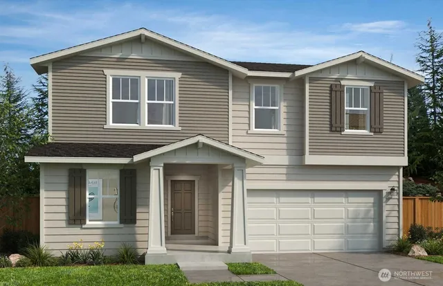 a front view of a house with garage