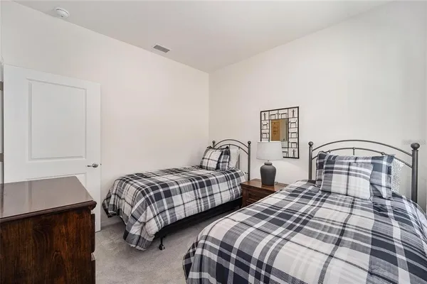 a bedroom with two beds and a window
