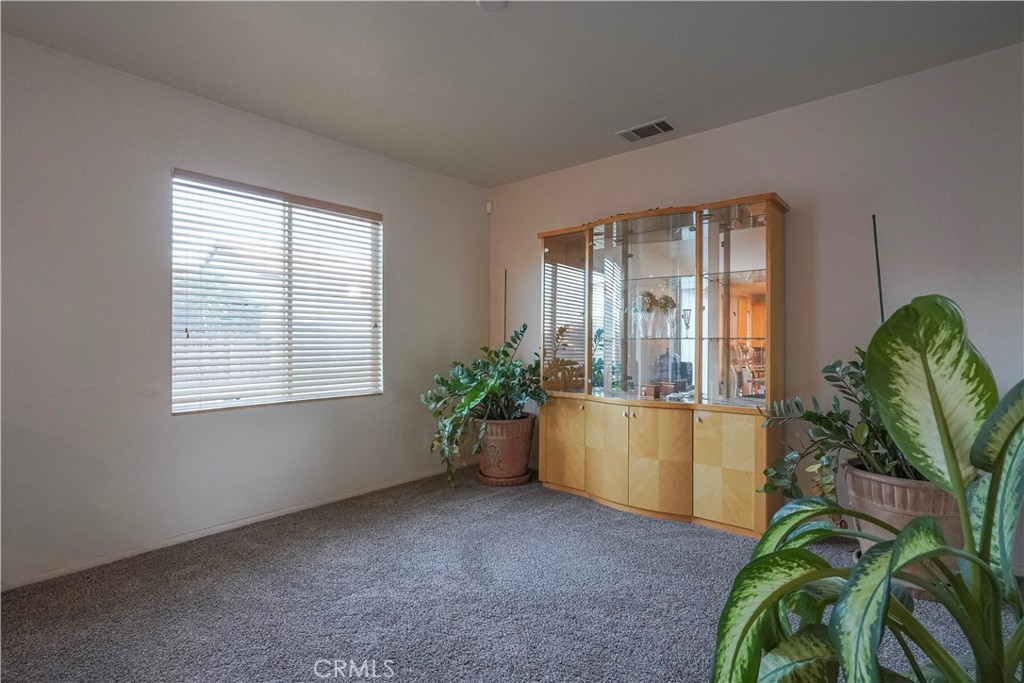 15133 Pasture Way Victorville, CA 92394 - Photo 11 of 48 a living room with window and a potted plant
