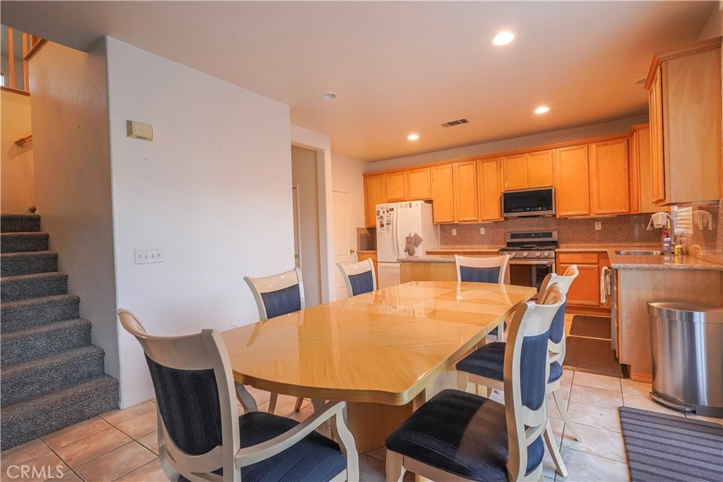 15133 Pasture Way Victorville, CA 92394 - Photo 15 of 48 a view of a dining room with furniture window and wooden floor