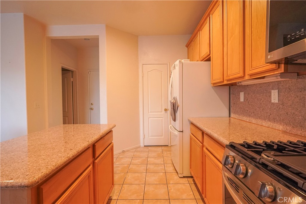15133 Pasture Way Victorville, CA 92394 - Photo 22 of 48 a kitchen with a sink and a stove top oven