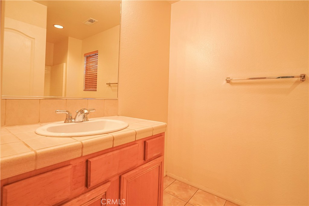 15133 Pasture Way Victorville, CA 92394 - Photo 31 of 48 a bathroom with a sink and a mirror