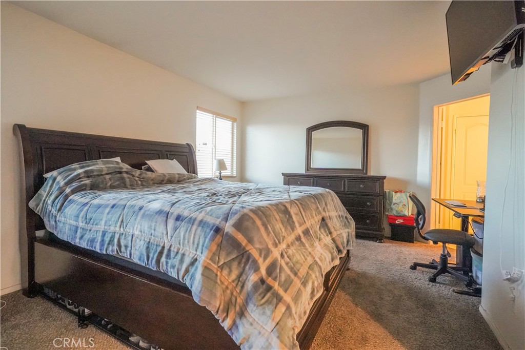 15133 Pasture Way Victorville, CA 92394 - Photo 37 of 48 a bedroom with a bed and a mirror on dresser