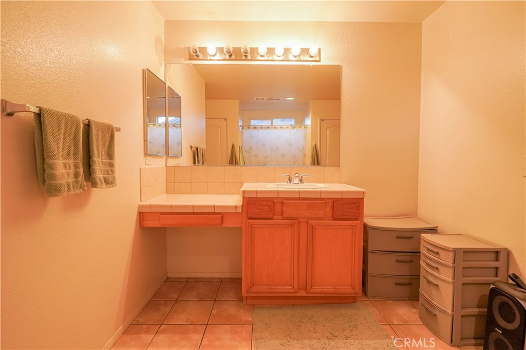 15133 Pasture Way Victorville, CA 92394 - Photo 41 of 48 a bathroom with a sink and a mirror