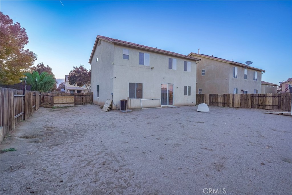 15133 Pasture Way Victorville, CA 92394 - Photo 46 of 48 a view of a house with backyard and a tree