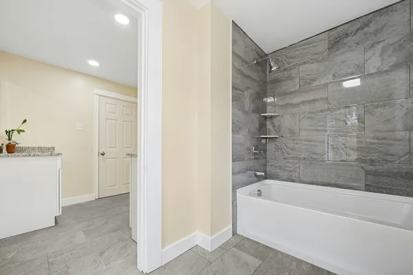 a view of bathroom with a sink and mirror