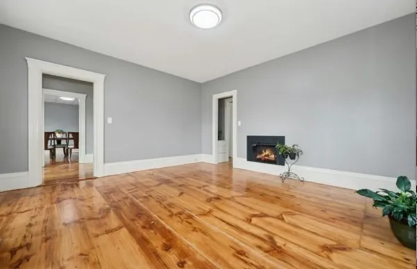 a view of an empty room and wooden floor