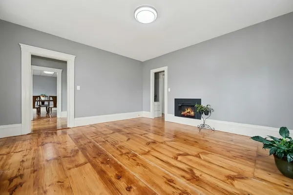 a view of an empty room and wooden floor