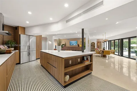 a bathroom with a bathtub a double vanity sink a vanity a window and a shower