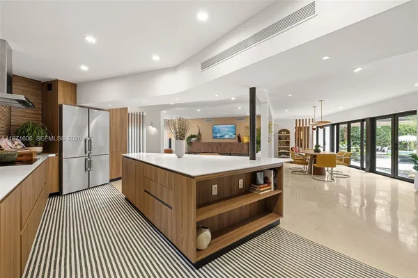a bathroom with a bathtub a double vanity sink a vanity a window and a shower