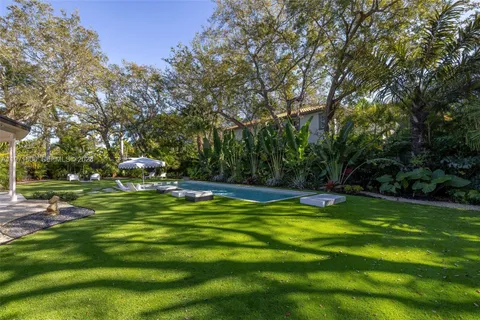 a view of a swimming pool with a yard